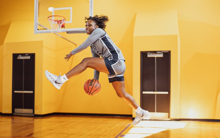 Keiarra Rivers of NAU passing the ball between her legs